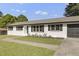 Single-story house with white brick, dark shutters, and a green lawn at 2704 Dove Ln, Raleigh, NC 27604