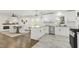 Bright kitchen with white cabinetry, stainless appliances, and an open layout to dining room at 2704 Dove Ln, Raleigh, NC 27604