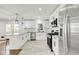 Modern kitchen with stainless steel appliances, white cabinets, and granite countertops at 2704 Dove Ln, Raleigh, NC 27604