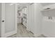 View through laundry room to bright white kitchen with modern appliances at 2704 Dove Ln, Raleigh, NC 27604