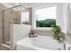 Bathroom featuring a soaking tub with a view, and a glass-enclosed shower at 2749 Nettles Ridge Way, Fuquay Varina, NC 27526