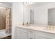 Bathroom featuring a double vanity with sinks, a large mirror, and a bathtub with a shower and curtain at 2749 Nettles Ridge Way, Fuquay Varina, NC 27526