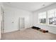 Bright bedroom with neutral carpet, an interior door, full-length mirror, and exterior windows at 2749 Nettles Ridge Way, Fuquay Varina, NC 27526