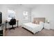 Bright bedroom featuring a bed, desk, and chair, along with carpet and windows allowing natural light at 2749 Nettles Ridge Way, Fuquay Varina, NC 27526
