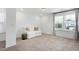 Bright, carpeted room with a white sofa, side table, neutral tones and plenty of natural light at 2749 Nettles Ridge Way, Fuquay Varina, NC 27526