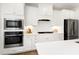Modern white kitchen featuring stainless steel appliances, subway tile backsplash, and a bright, clean design at 2749 Nettles Ridge Way, Fuquay Varina, NC 27526