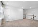 Upstairs landing featuring neutral carpet, white walls, and a staircase with white railings at 2749 Nettles Ridge Way, Fuquay Varina, NC 27526