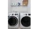 Bright laundry room featuring a new washer and dryer along with a shelf and storage for supplies at 2749 Nettles Ridge Way, Fuquay Varina, NC 27526