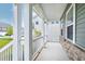 Spacious covered front porch with white pillars and railings, offering a relaxing outdoor space at 2749 Nettles Ridge Way, Fuquay Varina, NC 27526