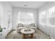 Cozy sitting room with comfortable chairs, soft lighting, and elegant sheer curtains providing natural light at 2749 Nettles Ridge Way, Fuquay Varina, NC 27526