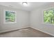 Bedroom with neutral carpet, two windows, and ample natural light at 2806 Shaftsbury St, Durham, NC 27704
