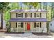 Charming two-story home with a inviting front porch and a bright red front door at 2806 Shaftsbury St, Durham, NC 27704