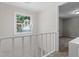 Upstairs hallway with a modern light fixture and view into bedroom at 2806 Shaftsbury St, Durham, NC 27704