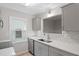Bright kitchen with stainless steel appliances, gray cabinets, and quartz countertops at 2806 Shaftsbury St, Durham, NC 27704
