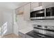 Modern kitchen features stainless steel appliances, updated lighting, and outdoor access at 2806 Shaftsbury St, Durham, NC 27704