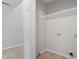 This laundry room is well-lit and has a shelf and hookups for a washer and dryer at 2806 Shaftsbury St, Durham, NC 27704