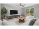 Bright living room features ceiling fan, decorative rug, and sliding glass door to deck at 2806 Shaftsbury St, Durham, NC 27704