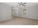 View of the living room with windows, ceiling fan, and wood-look floors at 2806 Shaftsbury St, Durham, NC 27704