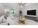 Light-filled living room showcasing modern decor, a ceiling fan, and comfortable seating at 2806 Shaftsbury St, Durham, NC 27704