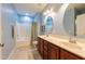 Bathroom with double sinks and a vanity with dark wood cabinets and a shower tub combo at 2810 Bedford Green Dr # 207, Raleigh, NC 27604