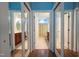 Hallway view of mirrored bathroom doors with dual bathrooms featuring dark wood vanities at 2810 Bedford Green Dr # 207, Raleigh, NC 27604