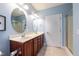 Bathroom with double sinks and a vanity with dark wood cabinets and a walk in shower at 2810 Bedford Green Dr # 207, Raleigh, NC 27604