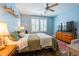Bright bedroom featuring a ceiling fan, large window with shutter blinds, and a red patterned area rug at 2810 Bedford Green Dr # 207, Raleigh, NC 27604