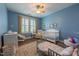 Bright Bedroom with a white crib, convertible dresser, comfortable glider, and shuttered window at 2810 Bedford Green Dr # 207, Raleigh, NC 27604