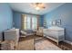 Cozy Bedroom with a white crib, convertible dresser, comfortable glider, and shuttered window at 2810 Bedford Green Dr # 207, Raleigh, NC 27604