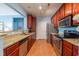 Well-equipped kitchen featuring granite countertops, stainless steel appliances, and warm wood cabinetry at 2810 Bedford Green Dr # 207, Raleigh, NC 27604