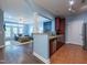 View of the living room with hardwood floors adjacent to kitchen with stainless steel appliances and granite countertops at 2810 Bedford Green Dr # 207, Raleigh, NC 27604