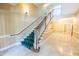 Well-lit staircase in building with carpet runner, wooden handrail, and elegant tile flooring at 2810 Bedford Green Dr # 207, Raleigh, NC 27604