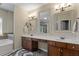 Bathroom showcasing dual vanities, decorative mirrors, and stylish lighting fixtures at 3009 Weston Green Loop, Cary, NC 27513
