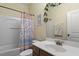 Bathroom showcasing a tub and shower combination with a decorative curtain and single sink vanity at 3009 Weston Green Loop, Cary, NC 27513