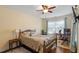 Comfortable bedroom with a wooden bed frame, workspace and a ceiling fan at 3009 Weston Green Loop, Cary, NC 27513