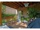 Relaxing covered patio featuring rocking chairs, a brick exterior, and lush plants at 3009 Weston Green Loop, Cary, NC 27513