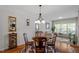 Cozy dining area with hardwood floors, elegant chandelier, and a round wood dining table at 3009 Weston Green Loop, Cary, NC 27513
