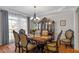 Elegant dining room featuring a decorative china cabinet, chandelier, and a large table with ornate chairs at 3009 Weston Green Loop, Cary, NC 27513