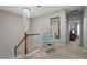 Hallway featuring a unique hanging chair, elegant light fixture, and a decorative mirror at 3009 Weston Green Loop, Cary, NC 27513