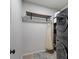 Laundry room with shelving, a hanging rack, and modern washer and dryer units at 3009 Weston Green Loop, Cary, NC 27513