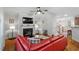 Inviting living room with a fireplace, comfortable red sectional, and hardwood floors at 3009 Weston Green Loop, Cary, NC 27513