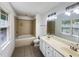 Bathroom featuring a jacuzzi tub, double sink vanity, and a large mirror at 301 Charleston Ln, Chapel Hill, NC 27517