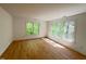 Bright bedroom filled with light from the many windows and hardwood floors at 301 Charleston Ln, Chapel Hill, NC 27517