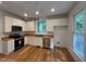 This kitchen is equipped with white cabinets, stainless steel appliances, and a wood countertop at 301 Charleston Ln, Chapel Hill, NC 27517