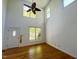 Bright living room with hardwood floors, a ceiling fan, and large windows at 301 Charleston Ln, Chapel Hill, NC 27517