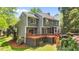 Lovely backyard featuring a spacious deck, screened-in porch, mature trees and established landscaping at 311 Arlington Rdg, Cary, NC 27513