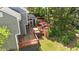 Aerial view of a house with a large wooden deck and steps down to the lawn at 311 Arlington Rdg, Cary, NC 27513