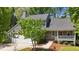 Exterior view of the home, surrounded by mature trees and landscaping at 311 Arlington Rdg, Cary, NC 27513