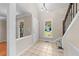 Inviting foyer with tile flooring, a staircase, and natural light from the front window at 311 Arlington Rdg, Cary, NC 27513