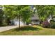 Charming home with a covered front porch, a well-manicured lawn, and a two-car garage at 311 Arlington Rdg, Cary, NC 27513